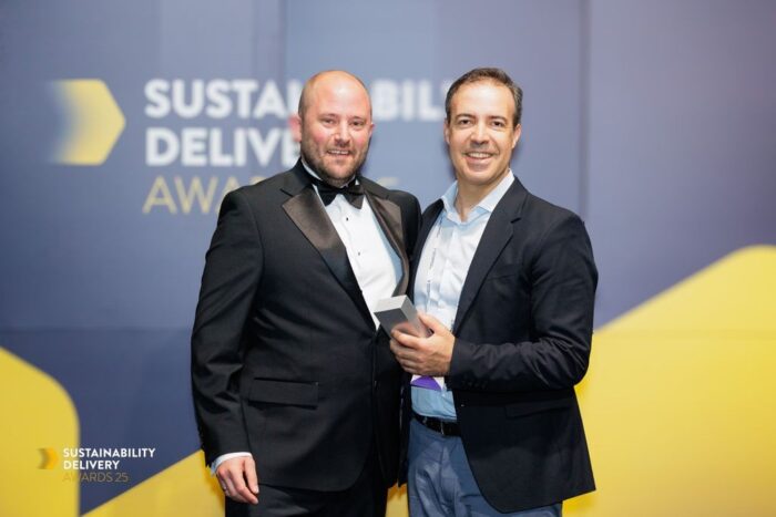 Bentley Systems’ Director of Sustainability, Rodrigo Fernandes (standing right), accepts a 2025 Sustainability Delivery Award from Ross Griffiths, Managing Director, Environment Analyst (standing left). (Image: Bentley Systems)